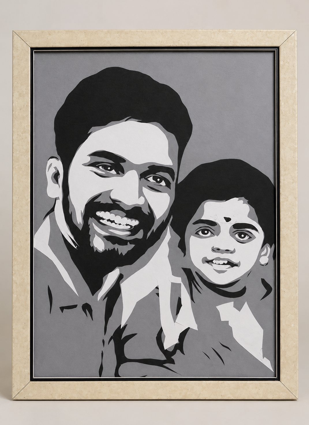 Framed paper-cut portrait of a smiling bearded man with a young child