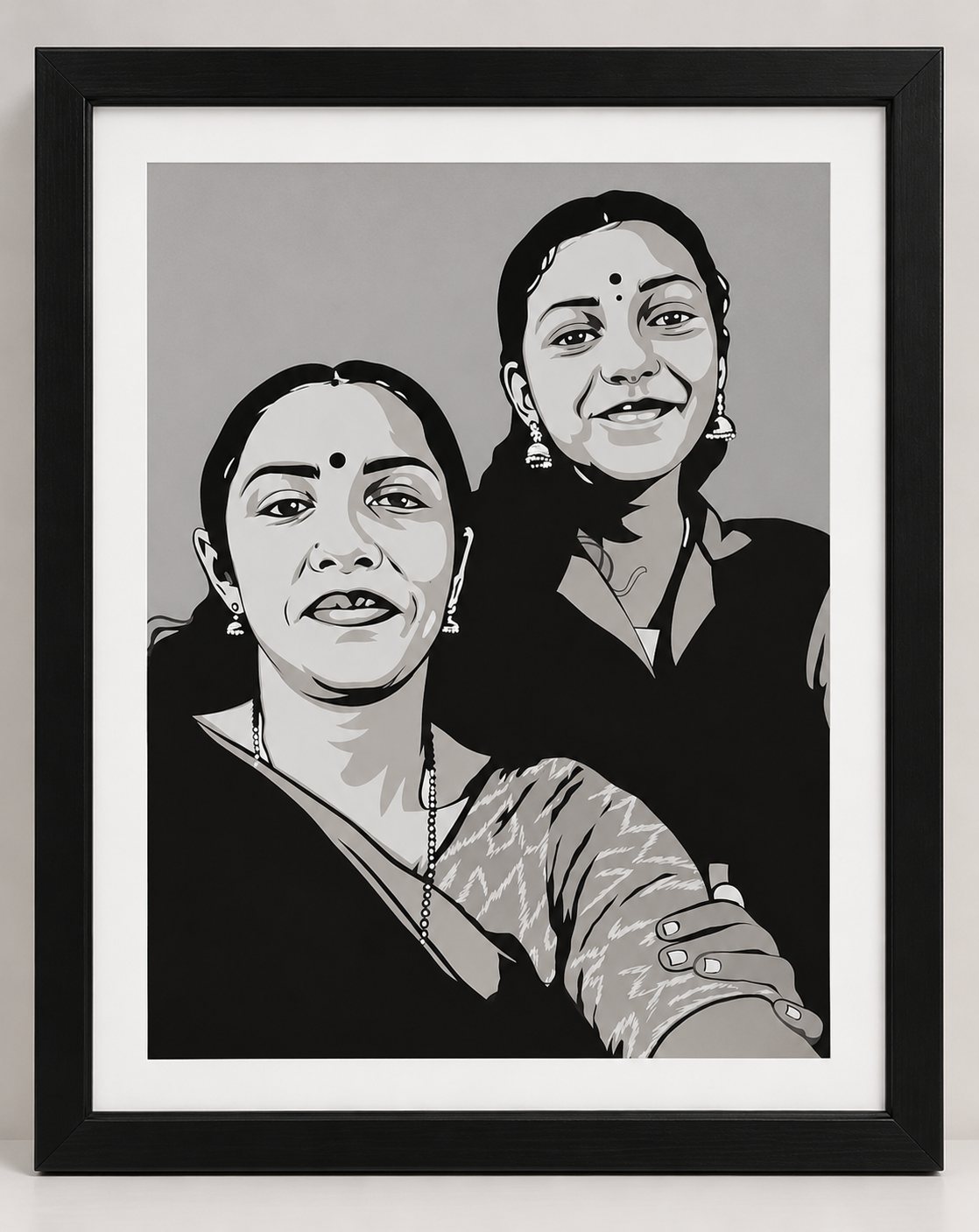 Framed paper-cut portrait of two smiling women in traditional attire