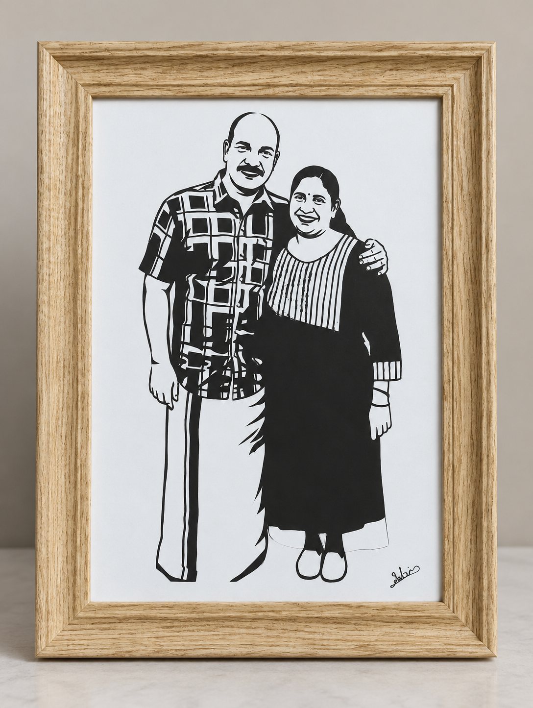 Framed paper-cut silhouette of a standing couple in traditional dress