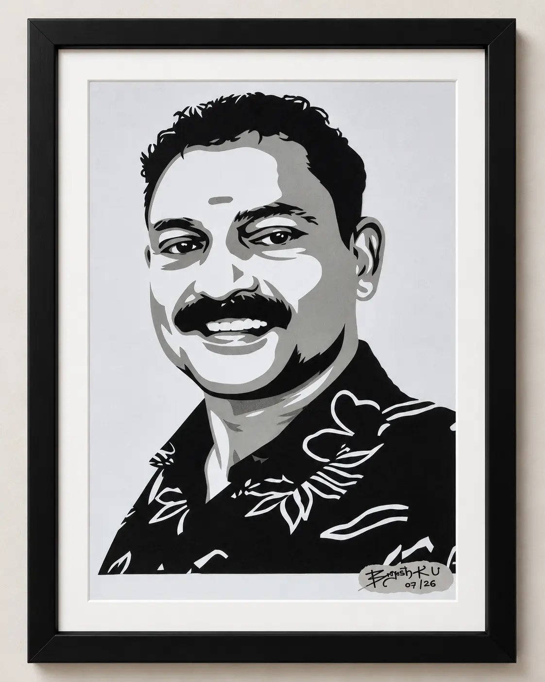 Framed paper-cut portrait of a smiling man in a patterned shirt