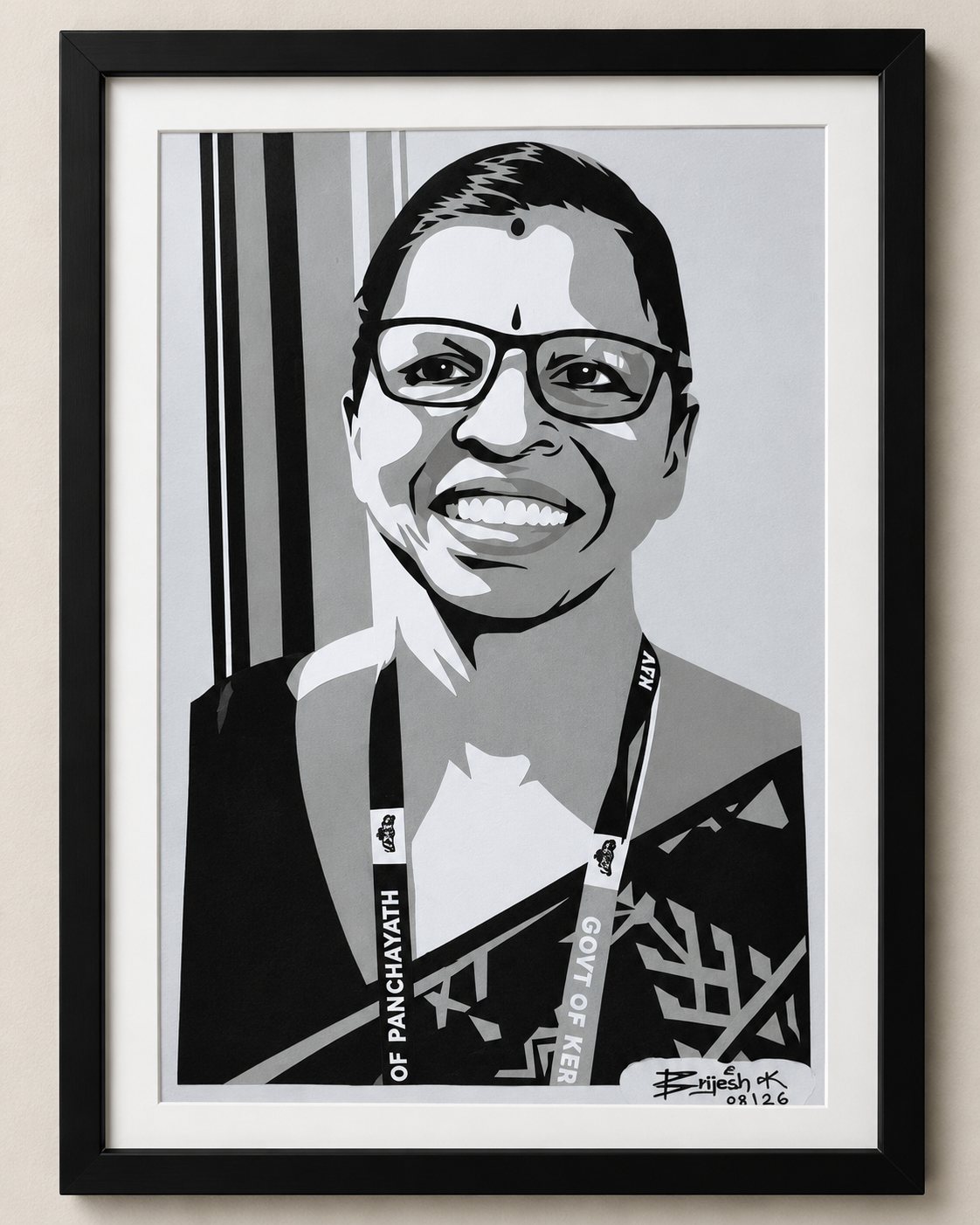 Framed paper-cut portrait of a smiling woman wearing glasses and an ID lanyard