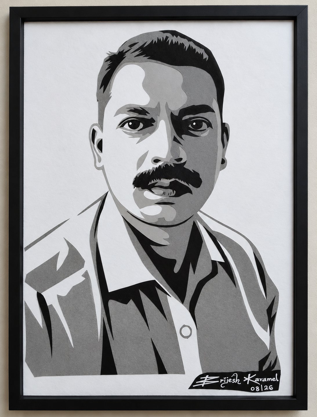 Framed multi-tone paper-cut portrait of a man with a mustache