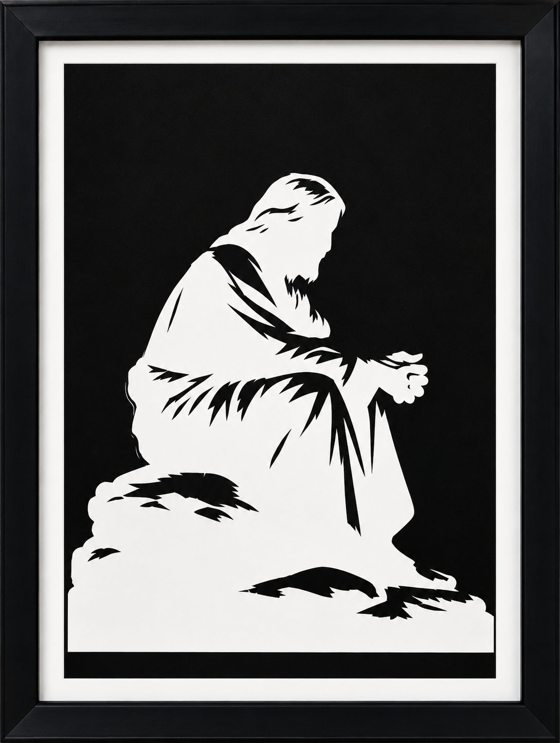 Framed two-tone paper-cut silhouette of a figure kneeling in prayer