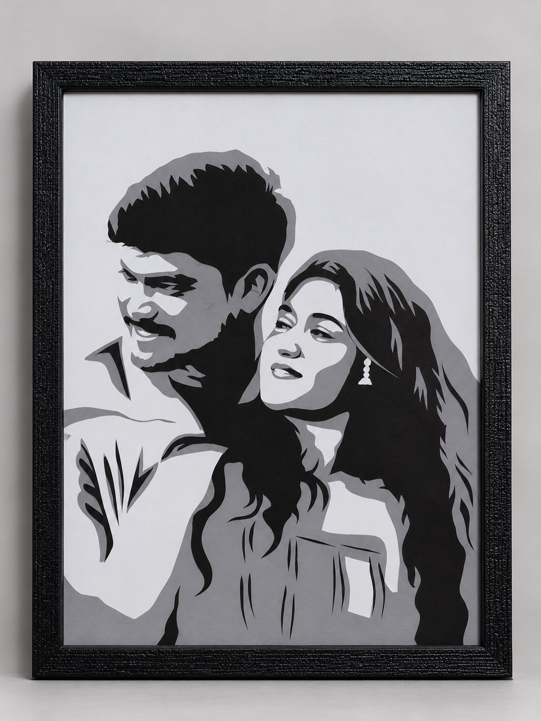 Framed paper-cut portrait of a young smiling couple embracing