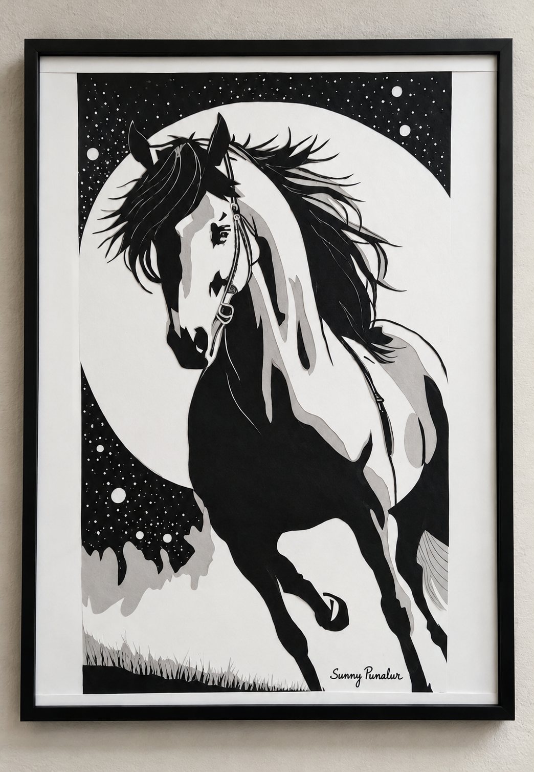 Framed paper-cut artwork of a galloping horse against a full moon