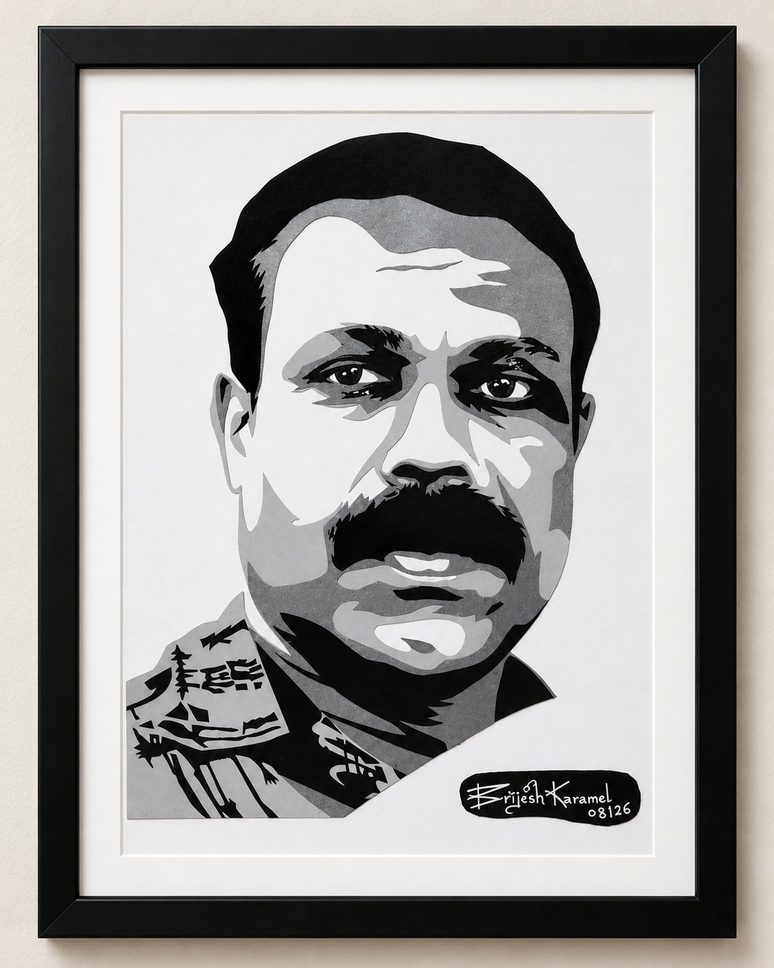 Framed paper-cut portrait of a man in a patterned military-style uniform