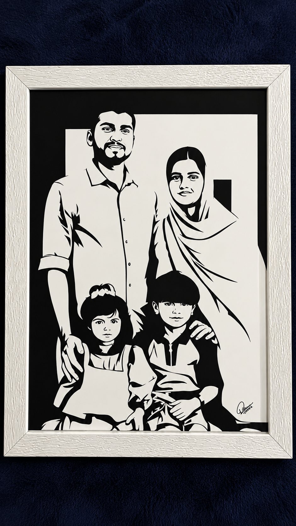 Framed paper-cut family portrait of four in a white frame