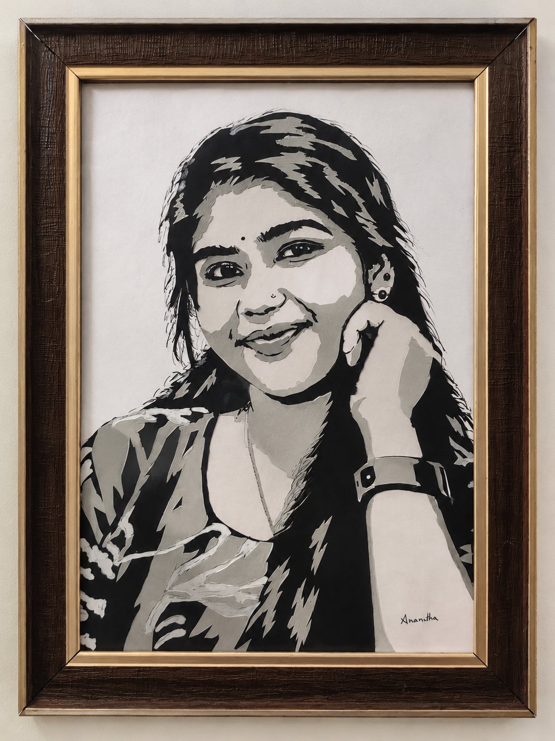 Framed paper-cut portrait of a smiling young woman with a wristwatch and earrings